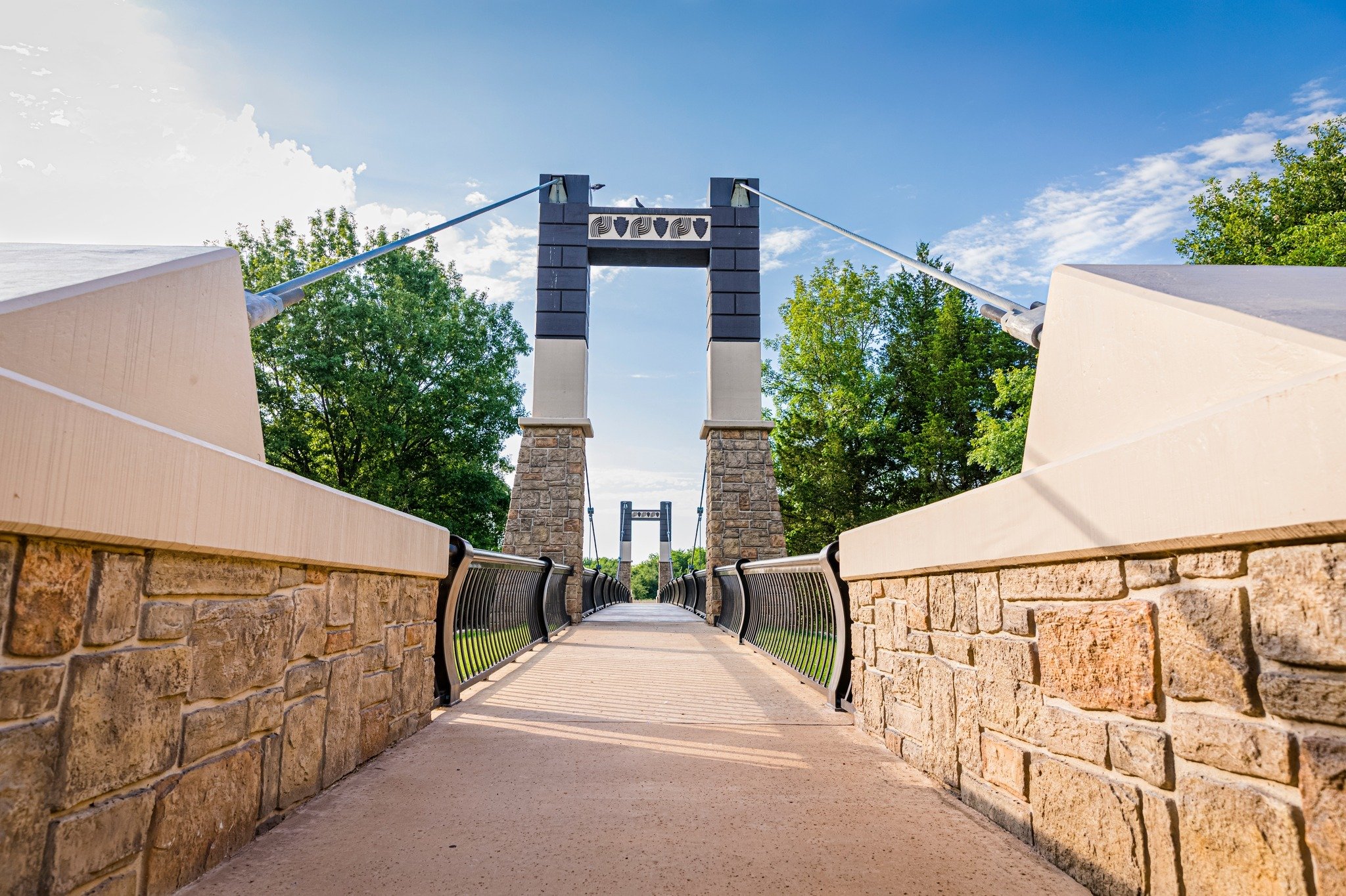 Looking down the walking path on the Inkana (Friendship) Bridge at the Chickasaw Cultural Center